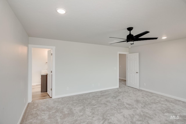 spare room featuring light carpet, ceiling fan, recessed lighting, and baseboards