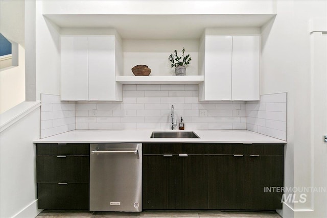 kitchen with open shelves, stainless steel dishwasher, a sink, and white cabinetry