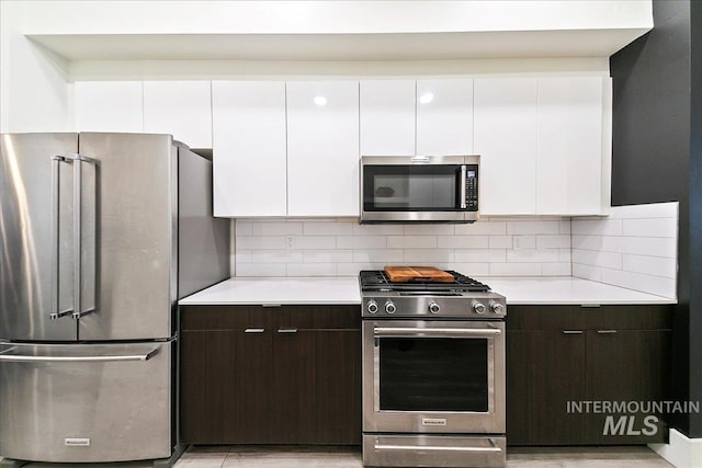 kitchen featuring light countertops, appliances with stainless steel finishes, and white cabinets