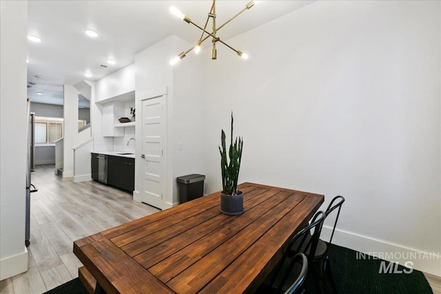 dining area with baseboards, recessed lighting, and light wood-style floors