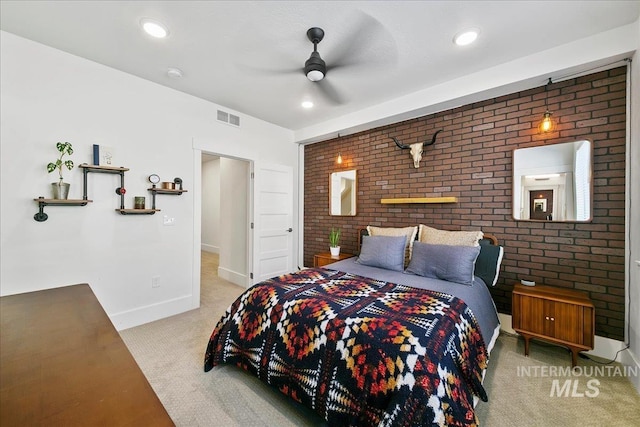 carpeted bedroom featuring recessed lighting, baseboards, visible vents, and brick wall