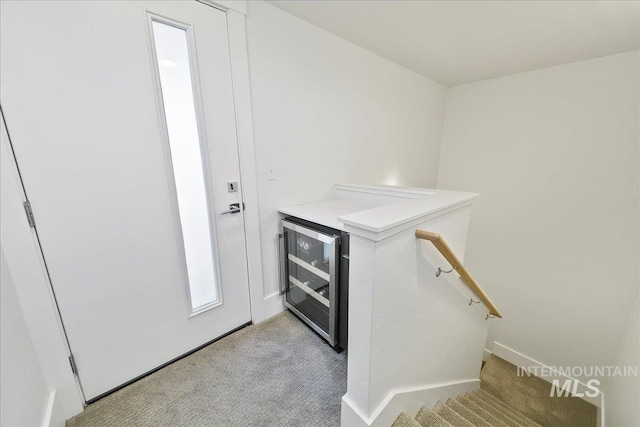 interior space featuring beverage cooler and carpet