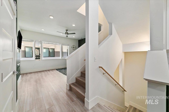 stairs with ceiling fan, baseboards, wood finished floors, and recessed lighting