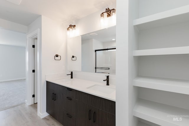 3819 W Tribute St, Meridian, ID 83642 - full bath featuring wood finished floors, double vanity, a shower with door, and baseboards