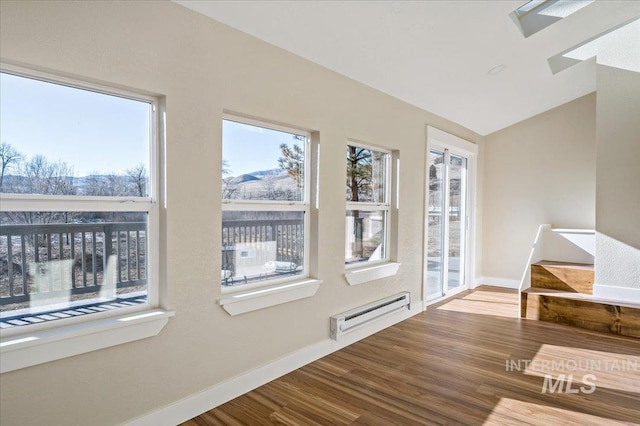 interior space with a baseboard radiator and lofted ceiling