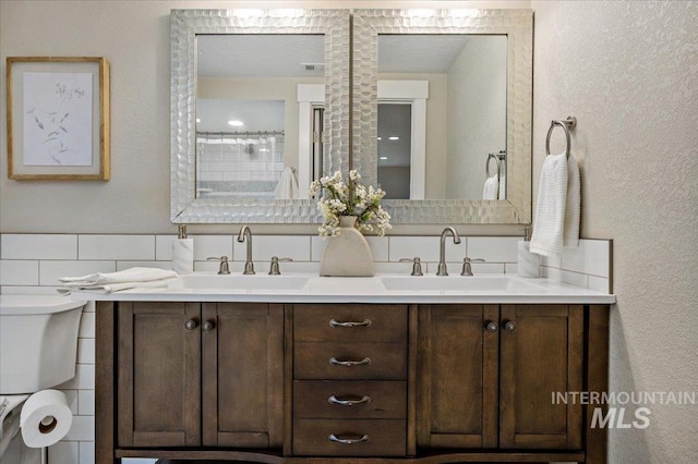 bathroom featuring decorative backsplash, tile walls, toilet, and vanity