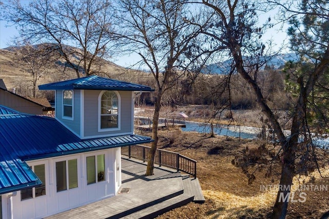 exterior space with a deck with mountain view