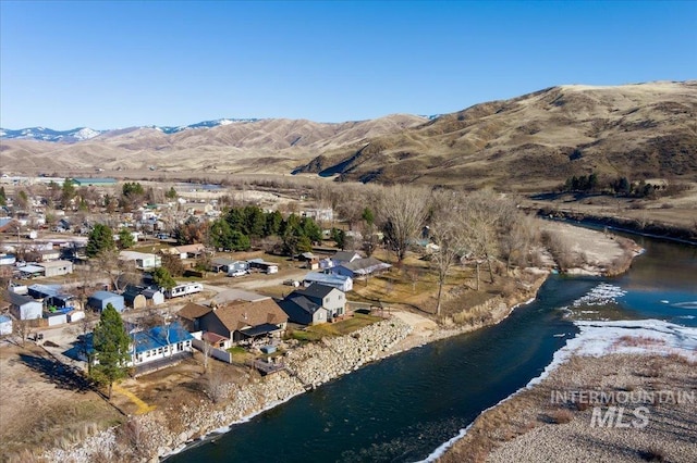 aerial view featuring a water and mountain view