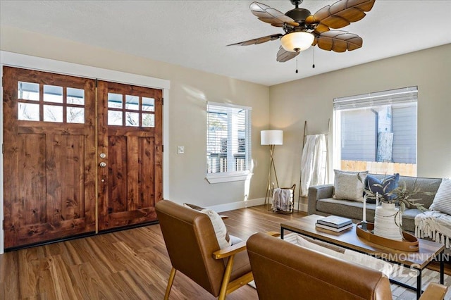 living room with light hardwood / wood-style floors and ceiling fan