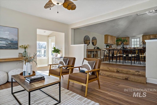 sitting room featuring light hardwood / wood-style floors, lofted ceiling, and ceiling fan