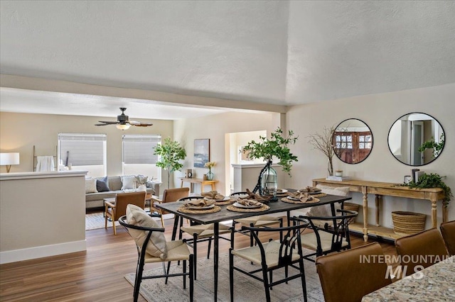 dining room with hardwood / wood-style flooring, a textured ceiling, and ceiling fan