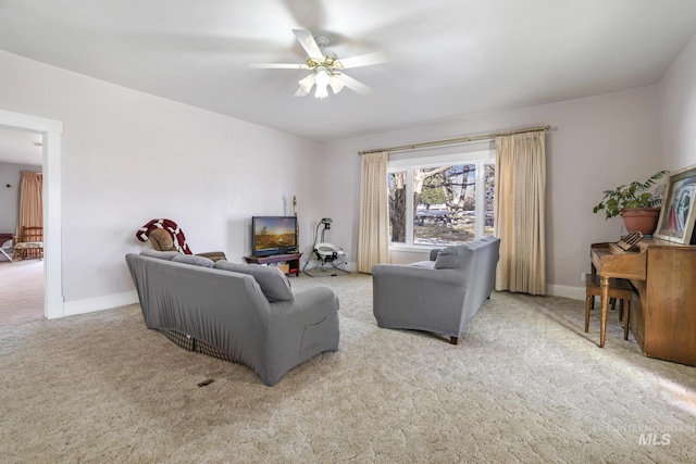 living room with a ceiling fan, carpet flooring, and baseboards