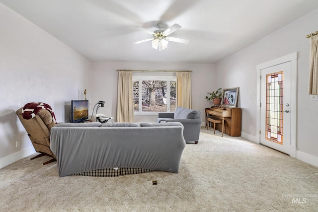 carpeted living room with ceiling fan and baseboards