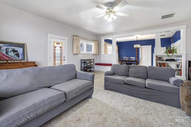 living room with ceiling fan, carpet flooring, and visible vents