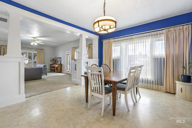 dining room with ceiling fan and decorative columns