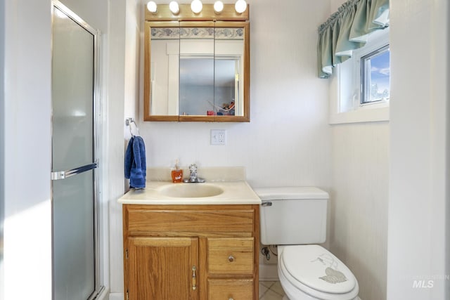 bathroom featuring a shower with shower door, vanity, and toilet