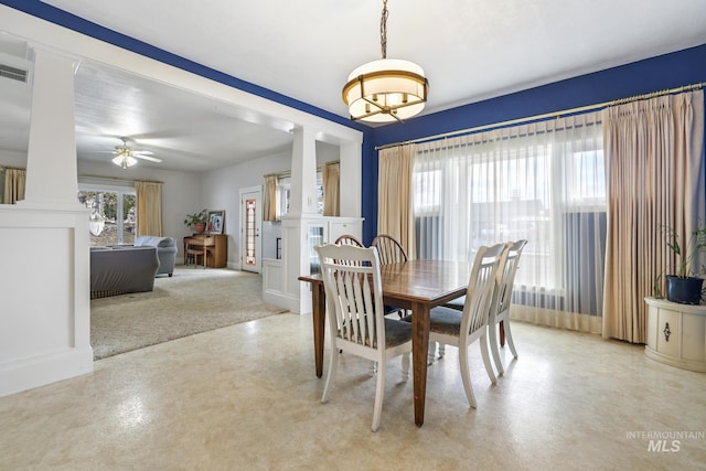 dining area with decorative columns and a ceiling fan