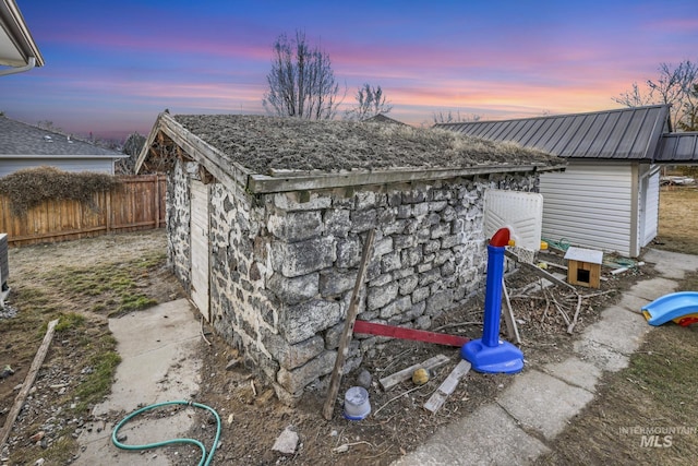 view of outdoor structure featuring an outbuilding and fence