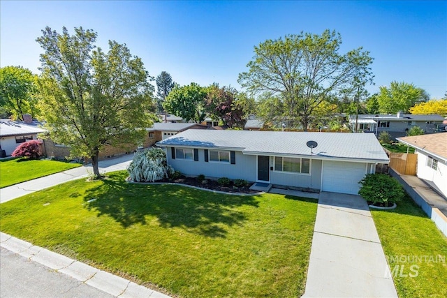 single story home featuring a garage and a front yard