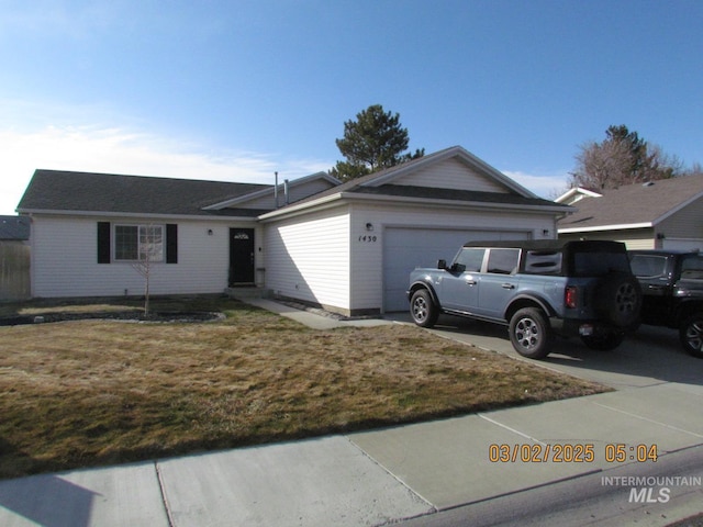 ranch-style home with a front lawn, concrete driveway, and an attached garage