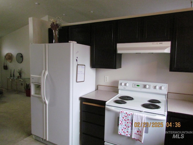 kitchen with light countertops, white appliances, exhaust hood, and dark cabinets