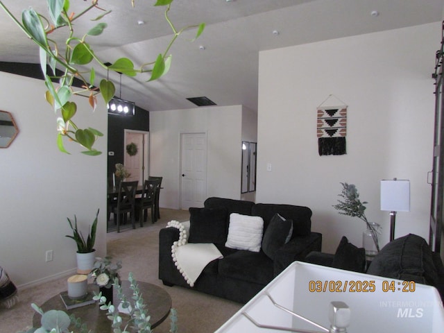 living area featuring visible vents and carpet flooring