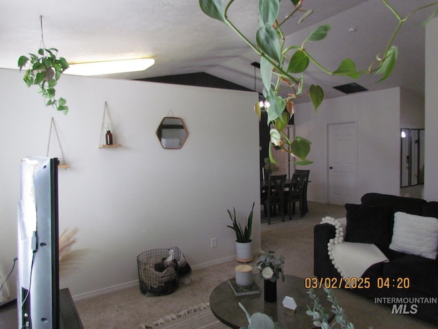 carpeted living room with lofted ceiling