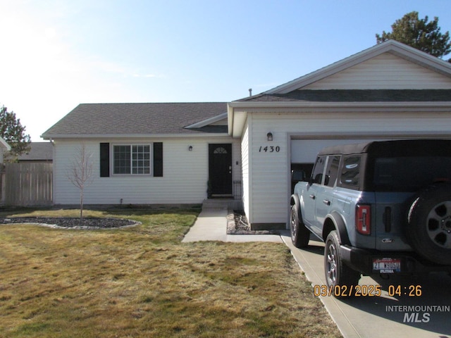 single story home with a garage and a front lawn