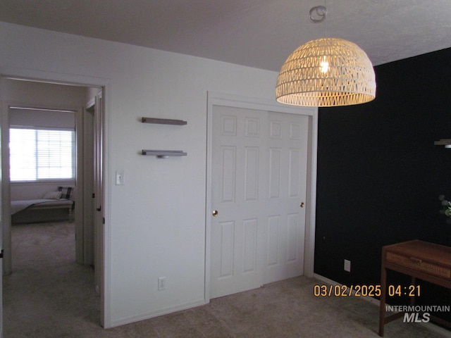 unfurnished bedroom featuring carpet flooring and baseboards