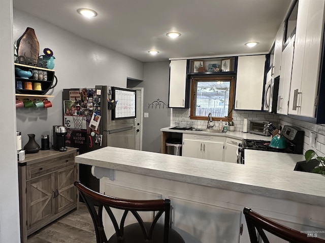 821 3rd St, Lewiston, ID 83501 - kitchen with stainless steel appliances, a peninsula, light countertops, decorative backsplash, and recessed lighting