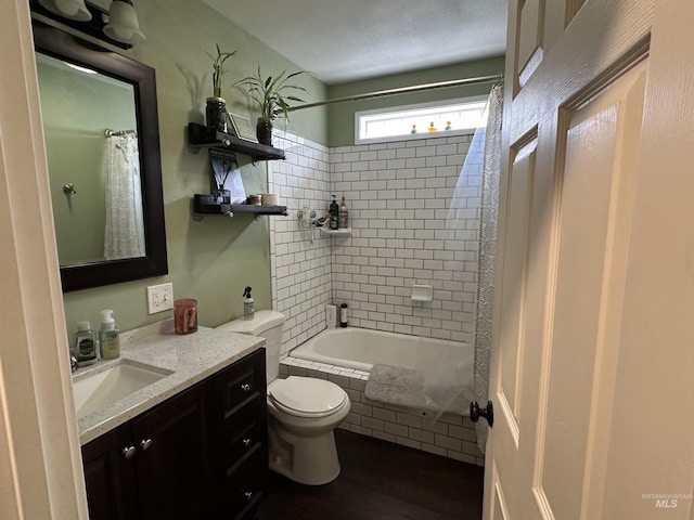 821 3rd St, Lewiston, ID 83501 - bathroom featuring vanity, tiled shower / bath, and wood finished floors