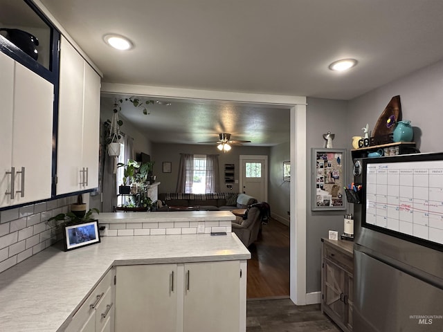 821 3rd St, Lewiston, ID 83501 - kitchen featuring a peninsula, light countertops, dark wood-style flooring, a ceiling fan, and open floor plan