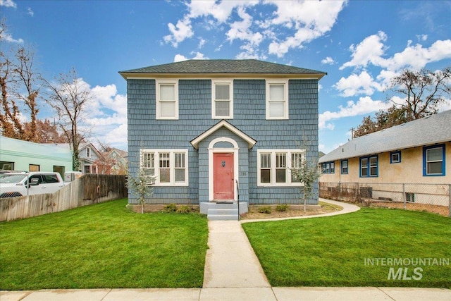 view of front of home featuring a front yard and fence