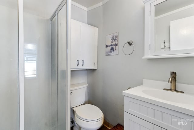 full bathroom featuring toilet, an enclosed shower, crown molding, and vanity