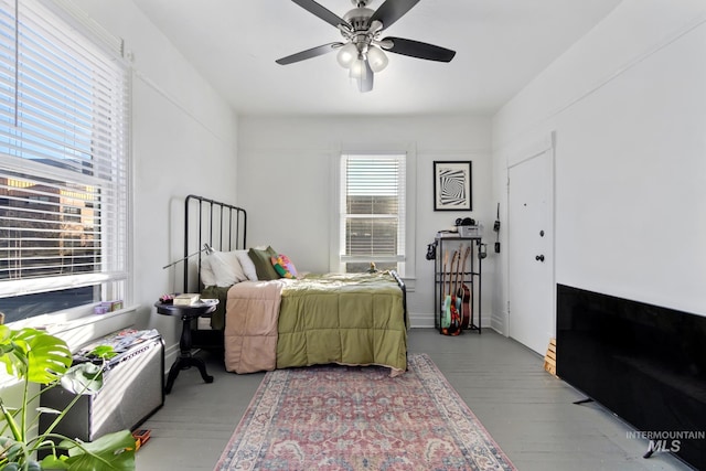 bedroom with ceiling fan and wood finished floors