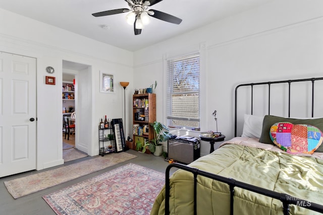 bedroom with ceiling fan and multiple windows