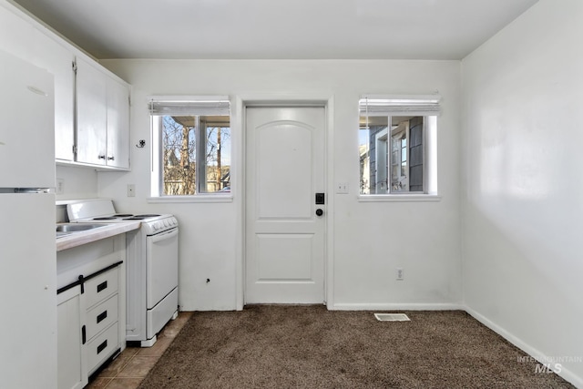 laundry room with carpet and visible vents