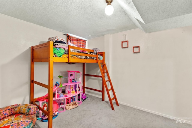 bedroom featuring carpet, baseboards, and a textured ceiling