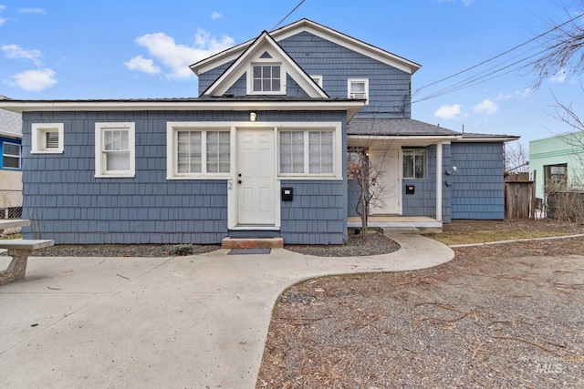 bungalow-style home with fence