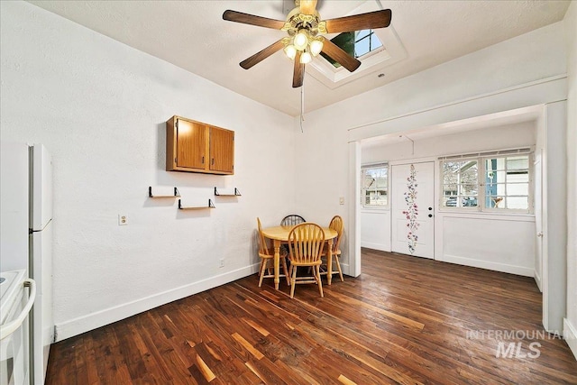 dining room featuring a ceiling fan, baseboards, and wood finished floors