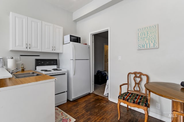 kitchen featuring light countertops, white appliances, a sink, and white cabinets