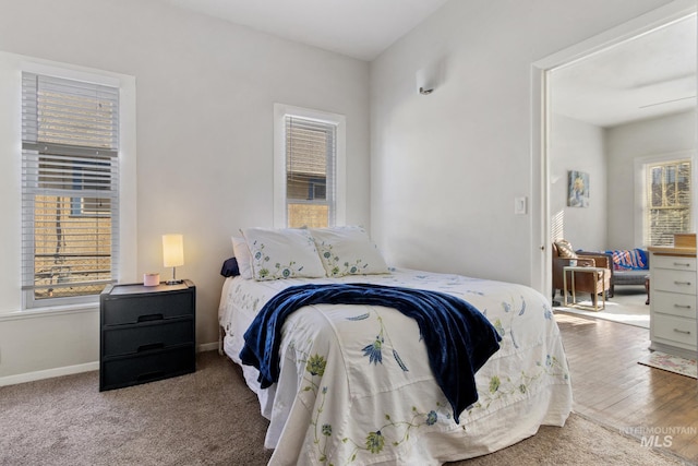 bedroom featuring baseboards and wood finished floors