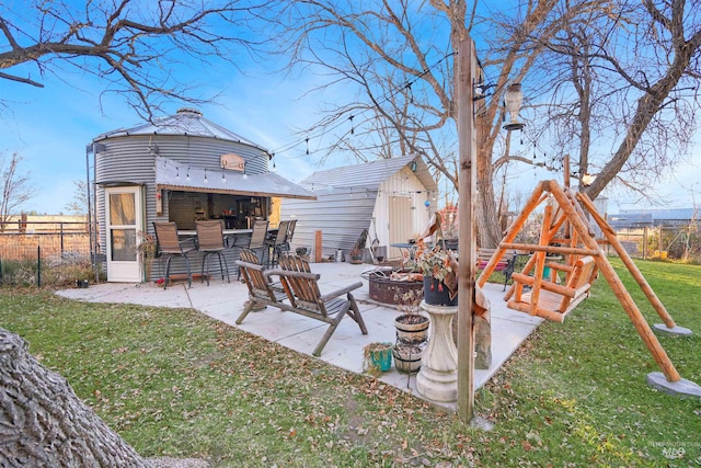 view of yard featuring a patio, exterior bar, and an outdoor fire pit