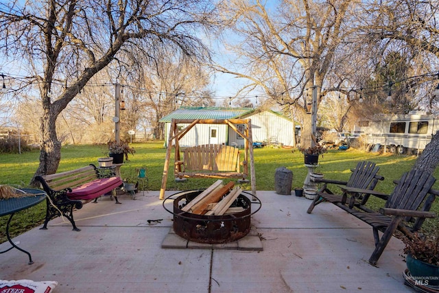 view of patio / terrace featuring an outdoor fire pit