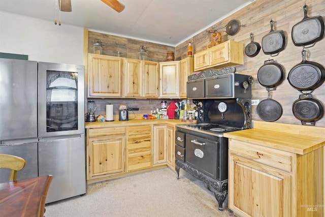 kitchen featuring stainless steel refrigerator, ceiling fan, butcher block counters, backsplash, and light brown cabinetry