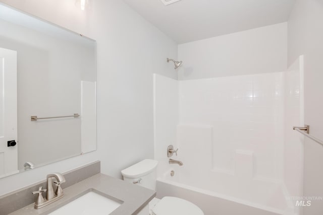 bathroom featuring toilet, shower / bathtub combination, and vanity