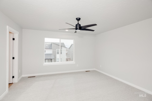 empty room with a ceiling fan, baseboards, visible vents, and carpet floors