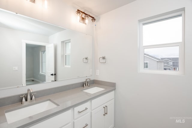 full bath featuring double vanity and a sink
