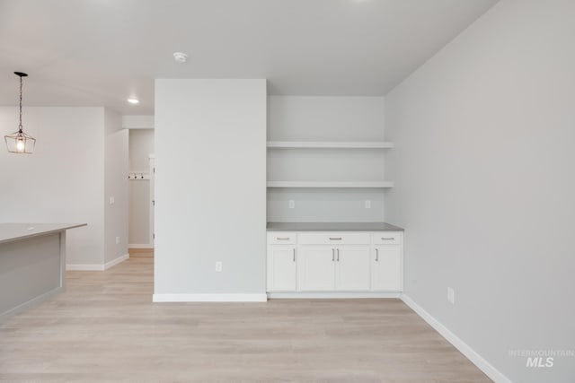 interior space with baseboards and light wood-style floors