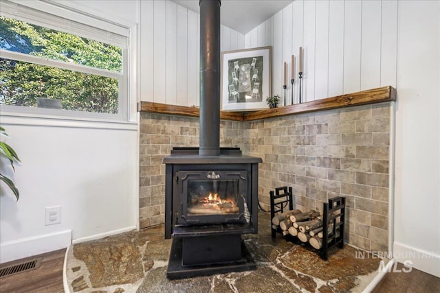 1984 11th Ave E, Twin Falls, ID 83301 - detailed view of a wood stove, baseboards, and wood finished floors